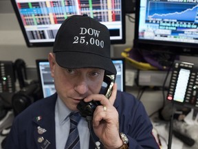 Vincent Pepe, a commodities broker with ICAP Corp., wears a Dow 25,000 hat to work at the New York Stock Exchange, Thursday, Jan. 4, 2018. The Dow Jones industrial average is trading above 25,000 points for the first time Thursday, just five weeks since its first close above 24,000.