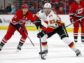 Calgary Flames' Sam Bennett carries the puck as Carolina Hurricanes' Jeff Skinner pursues during the first period on Sunday, Jan. 14, 2018, in Raleigh, N.C.