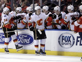 Calgary Flames' Matthew Tkachuk (19) is congratulated after scoring a goal during the second period of the team's NHL hockey game against the Florida Panthers, Friday, Jan. 12, 2018, in Sunrise, Fla. (AP Photo/Lynne Sladky) ORG XMIT: FLLS108