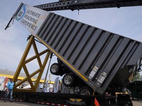 An attendee walks past hydraulic fracking equipment at the Global Petroleum Show in Calgary, Alta., Tuesday, June 7, 2016. New research has clarified how hydraulic fracking causes earthquakes in northern Alberta.But scientists have a ways to go before they can use that knowledge to predict if fracking will cause tremblors in other areas.THE CANADIAN PRESS/Jeff McIntosh