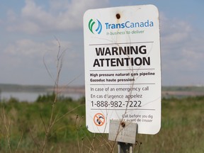 A sign from TransCanada warns of a natural gas pipeline near a Syncrude Canada operation north of Fort McMurray Alta. on Saturday June 28, 2014. Vince Mcdermott/Fort McMurray Today/QMI Agency