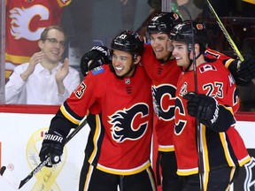 The Calgary Flames' Matthew Tkachuk celebrates scoring with Johnny Gaudreau and Sean Monahan during NHL action at the Scotiabank Saddledome on Calgary on Monday. Photo by Gavin Young/Postmedia.