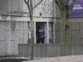 Toronto police attend Pauline Johnson School where a girl and her mother appeared before the media on Jan. 12, 2018, claiming that she had been attacked by a man who attempted to cut off her hijab. Police later said the incident never occurred.