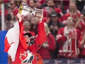 Canada forward Dillon Dubé (9) hoists the trophy after wining the gold medal, defeating Sweden in gold medal final IIHF World Junior Championships hockey action in Buffalo, N.Y., on Friday, January 5, 2018.