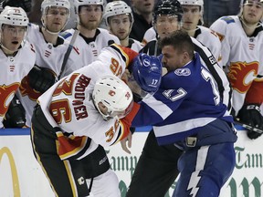 Calgary Flames right wing Troy Brouwer (36) and Tampa Bay Lightning left wing Alex Killorn (17) fight during the first period of an NHL hockey game Thursday, Jan. 11, 2018, in Tampa, Fla. Both players were given fighting major penalties. (AP Photo/Chris O'Meara) ORG XMIT: TPA105
