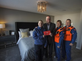 Liese Bielby, a Banff emergency medical services paramedic, STARS patient Jean-Francois Bussieres, Pat Jeffery, STARS flight nurse and John Doyle, STARS flight paramedic are pictured in the master bedroom of the 2018 STARS lottery show home on Thursday, Jan. 11, 2018. This grand prize home was built by Trico Homes and has a retail value of $948,000. Kerianne Sproule/Postmedia