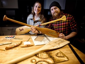 Canadaís top Womenís Canoe Slalom paddler Haley Daniels, 27, and her younger brother Hayden, 23, show off paddles that their father painted for them when they were young. The elder Daniels is hosting a painted paddle auction fundraiser on Wednesday, January 17, 2018, at which the younger Daniels will auction off a painted paddle that he designed. Leah Hennel/Postmedia