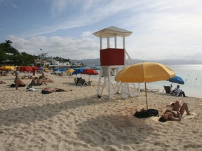 Tourists sunbathing at Doctor Cave beach in Montego Bay, Jamaica.