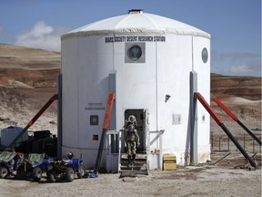 Crew members emerge from the main living quarters at the Mars Desert Research Station in Utah.