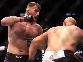 Stipe Miocic (left) prepares to throw a punch during his fight against Junior Dos Santos at UFC 211 on May 13, 2017 in Dallas. (Ronald Martinez/Getty Images)