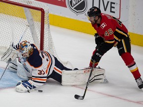 Oilers goalie Cam Talbot makes a save on Flames Marek Hrivik during a preseason game on September 18, 2017. in Edmonton.