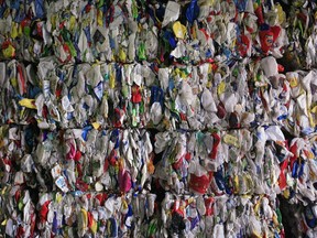 Recyclable materials compressed into large cubes are stacked in Toronto. A Chinese ban on most foreign recycling material is leaving some Canadian municipalities, including Calgary, with stockpiles of paper and plastics, much of which may eventually end up in the dump.
