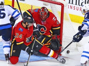 Mike Smith turns away the Winnipeg Jets to help his Calgary Flames earn a point Saturday, Jan. 20 at the Saddledome.
