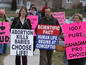 Pro-choice group Love Team Peterborough march carrying bright pink signs alongside the Peterborough Pro-Life group outside Peterborough Regional Health Centre (PRHC) on Saturday April 15, 2017