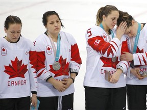 Canada defenseman Jocelyne Larocque, left, Canada defenseman Brigette Lacquette , Canada defenseman Lauriane Rougeau and forward Rebecca Johnston after losing to the United Statesin women's hockey at the 2018 Olympic Winter Games in Pyeongchang, South Korea, on Wednesday, February 21, 2018. Despite the loss that ended Canada's four straight championships, the country is still having an excellent Olympics, writes Valerie Fortney. Leah Hennel/Postmedia