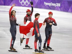 Samuel Girard, Charles Hamelin, Charle Cournoyer and Pascal Dion celebrate their silver medal in the men's 5,000-metre relay at the Pyeongchang Olympics on Feb. 22.
