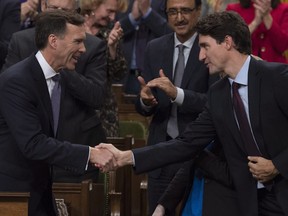 Finance Minister Bill Morneau shakes hands with Prime Minister Justin Trudeau after delivering his fall 2017 economic statement in the House of Commons.