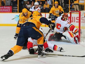 Goalie David Rittich #33 of the Calgary Flames makes a save on a shot by Kevin Fiala #22 of the Nashville Predators during the final moments of a Flames 4-3 victory at Bridgestone Arena on February 15, 2018 in Nashville, Tennessee.
