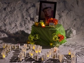 Mourners gathered at Airdrie's Nose Creek Park Sunday night to honour the life of 12-year-old Trai Schlichter, who passed away a week prior due to carbon monoxide exposure. (Zach Laing, Postmedia Network)   ORG XMIT: POS1802112131205604