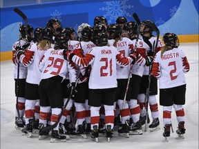 Team Canada celebrates after winning the women's semifinal game against the Olympic Athletes from Russia on Feb. 19, 2018.