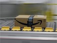 A box for an Amazon Prime customer moves through an Amazon Fulfillment Center, Friday, Feb. 9, 2018.