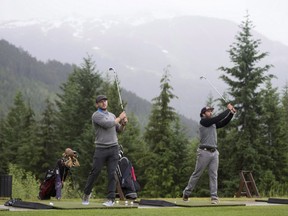 Bobsled athletes Chris Spring, right, and Justin Kripps hit shots at the Fairmont driving range in Whistler, B.C., Wednesday, June, 8, 2016. Spring and Kripps have taken up golf this summer as part of their training program, with a goal of sharpening focus and improving mental toughness. THE CANADIAN PRESS/Jonathan Hayward O