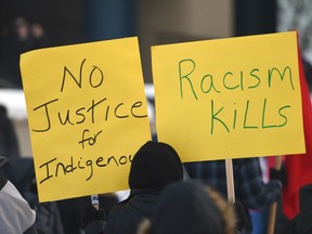 Supporters hold signs at the Justice for Colten Boushie rally in Calgary on Sunday.