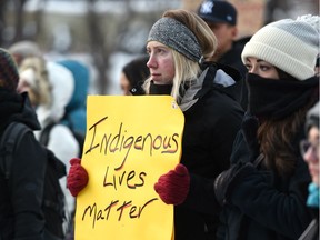 Attendees hold signs at the "Justice for Colten Boushie" rally in Calgary, Alta.  on Sunday, Feb. 11 2018. Bryan Passifiume/Postmedia Network