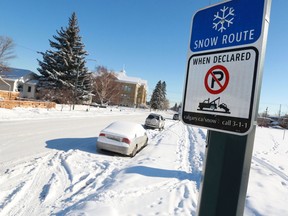 Cars remained parked in the snow route on 8th avenue  N.W. after a snow route park ban came into effect on Monday morning February 5, 2018.