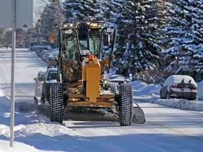 A City of Calgary grader clears snow along the snow route on 20th avenue N.W after a snow route parking ban came into effect on Monday February 5, 2018.