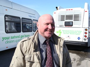 Calgary Transit spokesman Ron Collins in 2013 with two new natural gas buses.
