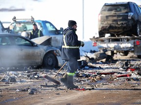 Crews clear a 40-vehicle pileup, which closed westbound lanes of Stoney Trail S.E. near the Bow River on Friday, Feb. 9, 2018.