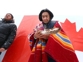 Gerald Menguinis, Tsuu T'ina First Nation performs part of a blessing/ prayer session in East Village in Calgary on Thursday, February 8, 2018 for the athletes travelling to South Korea for the winter Olympics. The City has also put up a wall for visitors to pass on messages of inspitation to athletes and travellers. Jim Wells/Postmedia