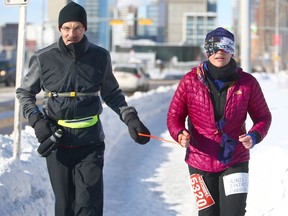 Char Hoyem (R), runs a full marathon in Calgary with her guide Saturday, February 10, 2018. Hoyem, whose son is legally blind, is training for the Boston Marathon later this year. Jim Wells/Postmedia