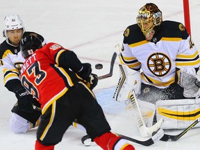 Boston Bruins Tuukka Rask makes a save on a shot by Sam Bennett of the Calgary Flames in overtime during NHL hockey at the Scotiabank Saddledome in Calgary on Monday, February 19, 2018. Al Charest/Postmedia