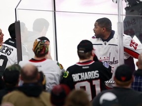 Washington Capitals right wing Devante Smith-Pelly (25) argues with Chicago Blackhawks fans from the penalty box during the third period of an NHL hockey game Saturday, Feb. 17, 2018, in Chicago. The Blackhawks won 7-1.