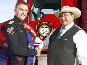 L-R, Calgary 9-1-1 Commander Doug Odney and Tsuut?ina Nation Chief Lee Crowchild shake hands during the signing ceremony of an agreement between The City of Calgary, Tsuut?ina Nation and Tsuut?ina Fire Department to deliver 9-1-1 services to Nation residents. This agreement is another example of how the distance between the two communities is lessening in an era of increased cooperation on Tuesday February 6, 2018. Darren Makowichuk/Postmedia
