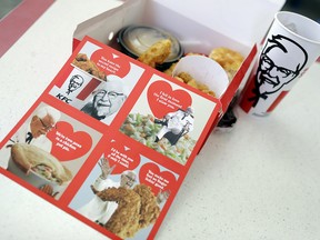 Valentine's Day scratch-and-sniff cards, which give off a fried chicken aroma, sit on a table at a KFC, Tuesday, Feb. 13, 2018, in Santa Clara, Calif. KFC is handing out the cards to diners who buy its $10 Chicken Share meals or a bucket full of Popcorn Nuggets.