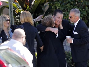 Family and friends console each other as they arrive for the funeral of Meadow Pollack, a victim of the Wednesday shooting at Marjory Stoneman Douglas High School, in Parkland, Fla., Friday, Feb. 16, 2018. Nikolas Cruz, a former student, was charged with 17 counts of premeditated murder on Thursday.