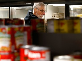 Volunteer Henry Horbay works at the Brockville and Area Food Bank. A growing number of Canadians say their lifestyle is falling behind.