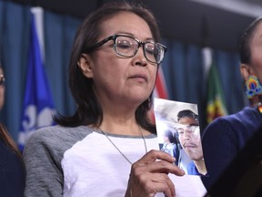 Debbie Baptiste, mother of Colten Boushie, holds a photo of her son on Parliament Hill on Wednesday.