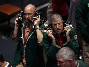 Traders work in the oil options pit at the New York Mercantile Exchange in this file photo.