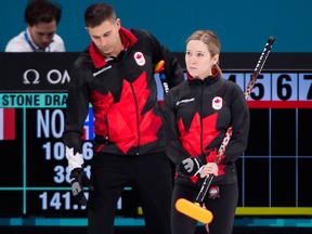 Canada's Kaitlyn Lawes, left, and teammate John Morris look on while playing against Norway during mixed doubles curling.