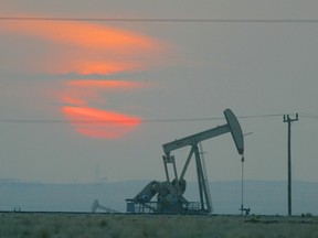 The sun sets behind a oil derek near the Saudi Arabian border.