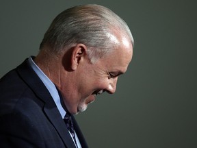 Premier John Horgan answers questions about the Alberta dispute during a press conference at the Legislature in Victoria, B.C., on Wednesday Feb. 7, 2018.