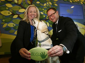 L-R, Sara Austin, CEO, Sheldon Kennedy Child Advocacy Centre, Alan Ross, Regional Managing Partner, Borden Ladner Gervais LLP and Webster, a The Sheldon Kennedy Child Advocacy Centre Facilty dog announced a new partnership with the The Sheldon Kennedy Child Advocacy Centre by donating $150,000 to support services for children on Tuesday February 27, 2018. Darren Makowichuk/Postmedia