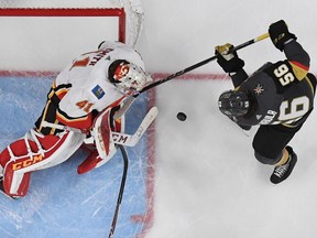 LAS VEGAS, NV - MARCH 18:  Mike Smith #41 of the Calgary Flames blocks a shot by Erik Haula #56 of the Vegas Golden Knights in the third period of their game at T-Mobile Arena on March 18, 2018 in Las Vegas, Nevada. The Golden Knights won 4-0.