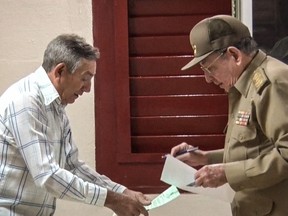 TV grab taken form Cuban Television on March 11, 2018, showing Cuban President Raul Castro (right) voting at a polling station in Santiago de Cuba Province during an election to ratify a new National Assembly.