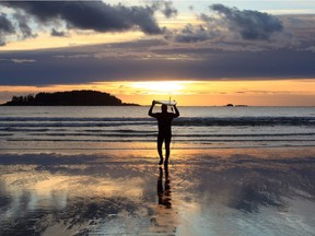 Andrew Penner heads out to sea with his board at Tofino. Courtesy, Dawn Penner