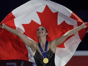 Kaetlyn Osmond of Canada celebrates after winning the women's free skating program, at the Figure Skating World Championships in Assago, near Milan, Italy, Friday, March 23, 2018. (AP Photo/Luca Bruno) ORG XMIT: FP176